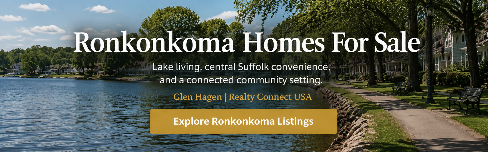 Lake shoreline with homes, walking path, mature trees, and benches in Ronkonkoma
